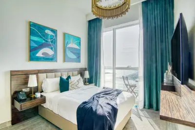 a bedroom with a large bed and a large window at GuestReady - Sea view retreat overlooking The Palm in Dubai