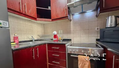 a kitchen with a sink and a stove top oven at Rare Holiday Homes - Mediterranean Cluster - Near Ibn Battuta Mall - Discovery Garden - Building# Med 65 - RG04 in Dubai