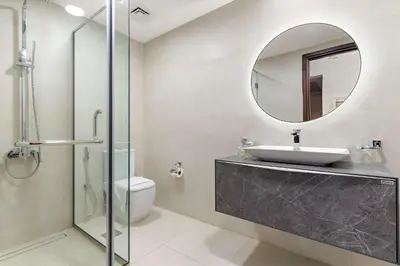 a bathroom with a sink and a mirror at Silkhaus Lavish 2BDR in Bay Square at Prime location in Dubai