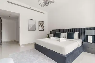 a white bedroom with a large bed in it at Silkhaus Lavish 2BDR in Bay Square at Prime location in Dubai