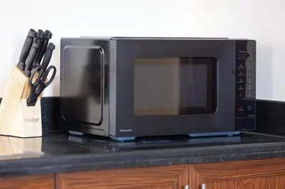 a microwave sitting on top of a kitchen counter at Panoramic Burj & Fountain Views 2BR in Dubai