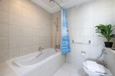 a bathroom with a tub and a toilet and a sink at Panoramic Burj & Fountain Views 2BR in Dubai