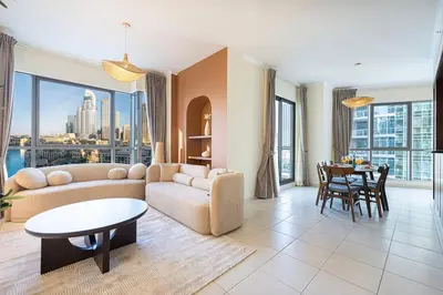 a living room with a couch and a table at Panoramic Burj & Fountain Views 2BR in Dubai