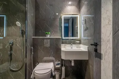 a bathroom with a toilet and a sink and a shower at Luxury at Its Finest, 2BR with Private Indoor Pool in Dubai