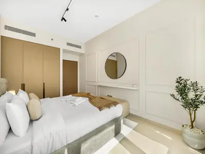 a bedroom with a large bed and a mirror at Spacious, Modern Chic 2 BDR Apartment in Prime Downtown Location in Dubai