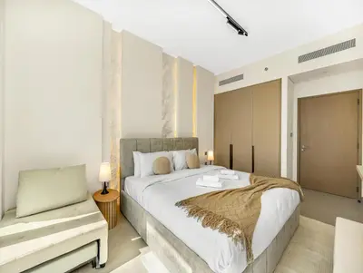 a bedroom with a large bed and a couch at Spacious, Modern Chic 2 BDR Apartment in Prime Downtown Location in Dubai