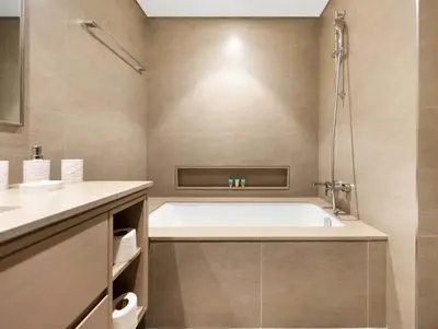 a bathroom with a tub and a sink at Spacious, Modern Chic 2 BDR Apartment in Prime Downtown Location in Dubai