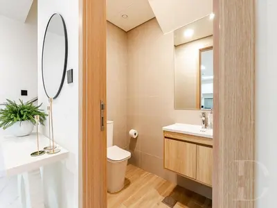 a bathroom with a toilet and a sink and a mirror at Cozy house suitable for family in Dubai