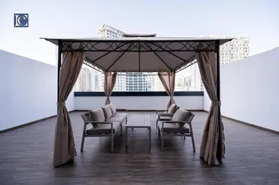 a gazebo with chairs and tables in a room at Luxury Escapes Modern 1 Bed Apt City View Sol Bay Business Bay in Dubai