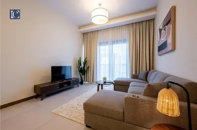 a living room with a couch and a tv at Luxury Escapes Modern 1 Bed Apt City View Sol Bay Business Bay in Dubai