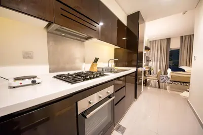 a kitchen with a stove and a counter top at Mejestic Studio in Dubai