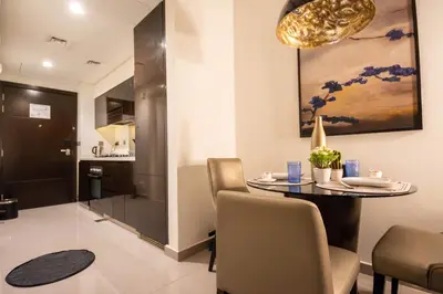 a dining room with a table and chairs at Mejestic Studio in Dubai
