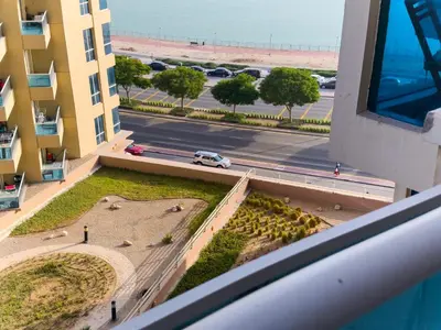 a view from a balcony of a building and a street at Spacious 2BR in Lago Vista Tower in Dubai