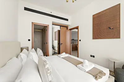 a bedroom with a large white bed with white pillows at VayK - Stylish Bright 1BR in JVC in Dubai