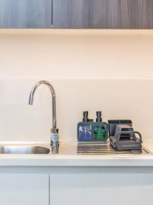 a kitchen counter top with a sink and a sink at Stylish Dubai Hills Retreat 1BR-Park Heights 2 T2 in Dubai