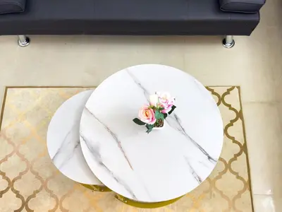 a white table with a flower on top of it at Stylish Studio Fast Wi-Fi 5 Min to Business Bay in Dubai