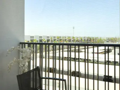a balcony with a view of a train station at Stylish Studio Fast Wi-Fi 5 Min to Business Bay in Dubai