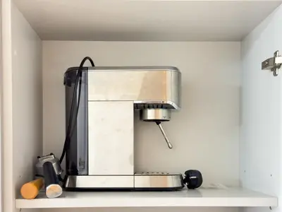 a blender sitting on a shelf in a kitchen at Stylish Studio Fast Wi-Fi 5 Min to Business Bay in Dubai
