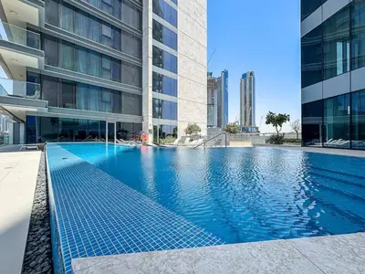 a swimming pool in the middle of a building at Stylish 1 BR in Canal Front with Pool and Gym Access in Dubai
