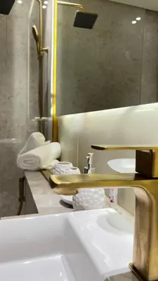 a bathroom with a sink and a mirror at Luxury Apartment in Binghatti Amber in Dubai