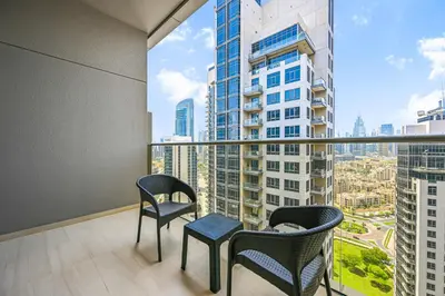 a balcony with two chairs and a table with a view at Luxury Studio Near Burj Khalifa in Dubai