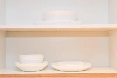 a shelf with bowls and plates on it at Luxury Studio Near Burj Khalifa in Dubai