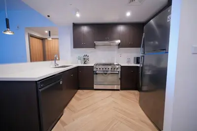 a kitchen with a sink and a stove top oven at Modern 1BR 4 guest apartment World Trade Center in Dubai