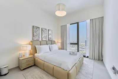 a bedroom with a large bed and a large window at FAM Living Grande 2Bed with Panoramic Burj Khalifa Fountain View in Dubai