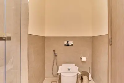 a bathroom with a toilet and a shower at FAM Living Grande 2Bed with Panoramic Burj Khalifa Fountain View in Dubai