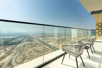 a balcony with two chairs and a view of the city at High-Floor 1BR with Balcony Overlooking the Lake, Minutes from the Park, Binghatti Onyx, Jumeirah Village Circle by Deluxe Holiday Homes in Dubai