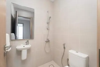 a white bathroom with a toilet and a sink at Luxury 3BR & Maid - Canal View - Near Downtown in Dubai