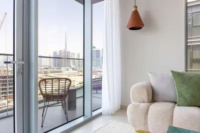 a living room with a chair and a window at Luxury 3BR & Maid - Canal View - Near Downtown in Dubai
