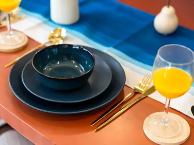 a table with a blue bowl and a glass of orange juice at Burj Khalifa View 2 Bedroom Apartment in Dubai