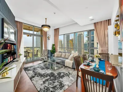 a living room with a couch and a table at Burj Khalifa View 2 Bedroom Apartment in Dubai
