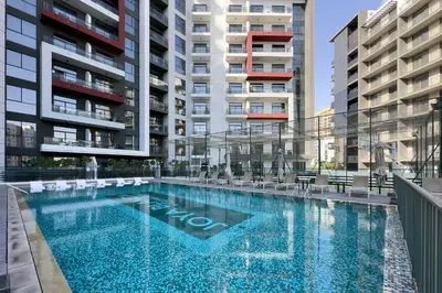 a swimming pool in the middle of some buildings at Luxury Retreat in Arjan with Refined Living in Dubai