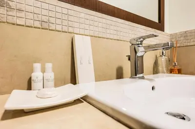 a bathroom counter with a sink and a mirror at FIRST CLASS 2BR Sky Views City Vibes in Dubai