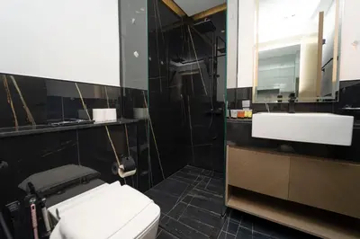 a bathroom with a white toilet and a sink at AWS Holiday Homes - Relaxing Stylish Studio in Dubai