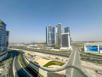 a highway in a city with tall buildings at AWS Holiday Homes - Relaxing Stylish Studio in Dubai