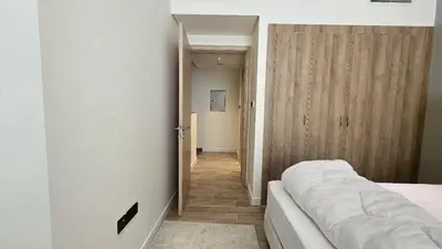 a bedroom with a bed and a hallway at Stylish 1BR Loft TH in Rukan in Dubai