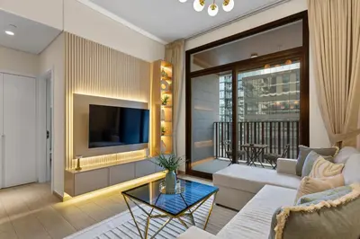 a living room with a couch and a tv at Art-Inspired 1 Bedroom in Wilton Terraces in Dubai