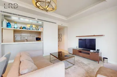 a living room with a couch and a flat screen tv at Iconic Burj View in Downtown Dubai in Dubai