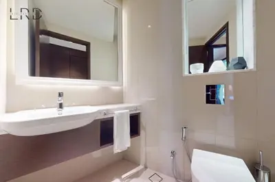 a bathroom with a sink and a toilet and a mirror at Iconic Burj View in Downtown Dubai in Dubai