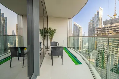 a balcony with chairs and a view of a city at Exclusive Burj Khalifa View, Steps From Dubai Mall, Infinity Pool in Dubai