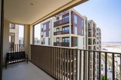 a balcony with a view of a building at Elegant at Creek Beach Lotus 1BHK in Dubai