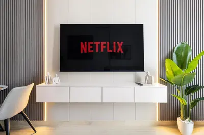 a tv on a white cabinet in a living room at Luxurious JVC Studio Near Circle Mall & Parks in Dubai