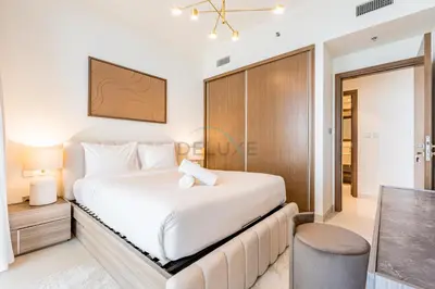 a bedroom with a white bed and a desk at 1BR With Private Beach Access, Near Dubai Marina Walk, Next to Dubai Harbour Marina & Yacht Club, Palace Beach Residence, Dubai Marina by Deluxe Holiday Homes in Dubai