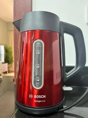 a red tea kettle sitting on a counter at The Dorra Bay Offers Stunning 2bedroom Duplex JBR Sea View Marina Canal view in Dubai