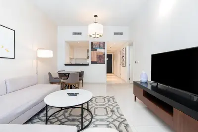 a living room with a couch and a flat screen tv at Ahlan HH - Stylish Suite Heart of Business Bay Avanti Tower in Dubai