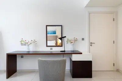 a desk with a mirror and a lamp on it at Ahlan HH - Stylish Suite Heart of Business Bay Avanti Tower in Dubai