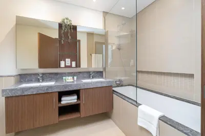 a bathroom with a sink and a tub at Vogue Marina 52-42 Towers near Ain Dubai and JBR Beach, Two Bedroom Apartment with Balcony Canal and Skyline views, Access to all Amenities in Dubai